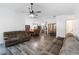 Spacious living room features hardwood floors, an open floor plan, and a modern ceiling fan at 722 Swaying Palm Dr, Apopka, FL 32712