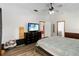 Bright main bedroom with hardwood floors, a ceiling fan, and neutral walls at 722 Swaying Palm Dr, Apopka, FL 32712