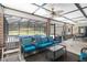 A screened-in porch featuring comfortable outdoor seating, a ceiling fan, and views of the pool and backyard at 722 Swaying Palm Dr, Apopka, FL 32712