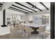 Dining room with a marble table, designer chairs, and view into the renovated, modern kitchen at 837 E Edgewood Dr, Lakeland, FL 33803