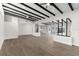 Open-concept living space with modern design, black beam ceilings, and hardwood floors at 837 E Edgewood Dr, Lakeland, FL 33803