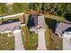 Aerial view of a single-Gathering home with a large lot, driveway, and surrounding neighborhood at 27 Perch Dr, Kissimmee, FL 34759