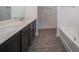 Bright bathroom featuring double vanity with white countertops and dark cabinetry at 27 Perch Dr, Kissimmee, FL 34759