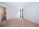 Bright, carpeted bedroom with a neutral color scheme, closet, and natural light from the window at 27 Perch Dr, Kissimmee, FL 34759