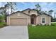 Charming single-story home with a well-manicured lawn, attached garage, and neutral color palette at 27 Perch Dr, Kissimmee, FL 34759