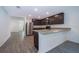 Modern kitchen with stainless steel appliances, granite countertops, and dark wood cabinets at 27 Perch Dr, Kissimmee, FL 34759
