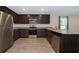 Updated kitchen featuring stainless steel appliances, granite countertops, and sleek dark cabinetry at 27 Perch Dr, Kissimmee, FL 34759