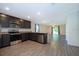 Spacious kitchen with stainless steel appliances, granite countertops, and a view into the living area at 27 Perch Dr, Kissimmee, FL 34759