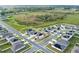 Aerial view of a residential neighborhood featuring modern homes, well-maintained lawns, and a surrounding green landscape at 271 Inman Blvd, Winter Haven, FL 33881