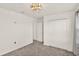 Cozy bedroom featuring carpeted floors, closet, and decorative lighting at 271 Inman Blvd, Winter Haven, FL 33881
