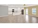 Bright, open kitchen featuring white cabinetry, stainless steel appliances, an island with sink, and tile flooring at 271 Inman Blvd, Winter Haven, FL 33881