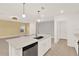 Bright kitchen featuring a spacious island with modern appliances and pendant lights at 271 Inman Blvd, Winter Haven, FL 33881