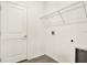 Clean laundry room with white walls, a wire shelf, and hookups for a washer and dryer at 271 Inman Blvd, Winter Haven, FL 33881