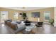 Bright living room with a comfortable gray sofa, sleek furnishings, and large windows providing ample natural light at 271 Inman Blvd, Winter Haven, FL 33881