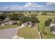 Aerial view of a home with solar panels, a well-maintained lawn, and mature trees at 4462 Iris S St, Lakeland, FL 33813
