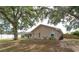 Backyard of a home with a large tree, screened-in porch, and partial fencing at 4462 Iris S St, Lakeland, FL 33813