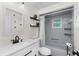 Bathroom features a modern vanity, decorative shelving and shower-tub combo at 4462 Iris S St, Lakeland, FL 33813