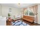 Bedroom featuring a crib, futon, surfboard, and a blue palm tree rug at 4462 Iris S St, Lakeland, FL 33813