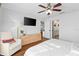 Bright bedroom with a ceiling fan, television, a comfortable chair, and an ensuite bathroom at 4462 Iris S St, Lakeland, FL 33813