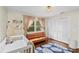 Bedroom with crib, surfboard, futon, white closet, and palm tree themed rug at 4462 Iris S St, Lakeland, FL 33813