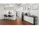 Open dining area with dark wood floors, a coffee bar, and views of the kitchen at 4462 Iris S St, Lakeland, FL 33813