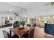 Bright dining room with a large mirror, wood table, and windows with curtains at 4462 Iris S St, Lakeland, FL 33813
