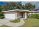 Close up of front entrance, showing the front door, landscaped yard and two car garage at 4462 Iris S St, Lakeland, FL 33813