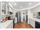 The kitchen boasts stainless steel appliances, including a modern refrigerator, and ample storage in white cabinets at 4462 Iris S St, Lakeland, FL 33813