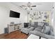 Inviting living room with a large gray sectional sofa, entertainment center and a ceiling fan at 4462 Iris S St, Lakeland, FL 33813