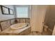 Relaxing bathroom with soaking tub and tile accents at 7810 Whitemarsh Way, Reunion, FL 34747