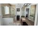 The spacious bathroom features a glass shower and granite countertops with a large mirror at 7810 Whitemarsh Way, Reunion, FL 34747