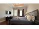 Spacious bedroom boasts a television and sleek hardwood floors at 7810 Whitemarsh Way, Reunion, FL 34747