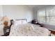 Comfortable bedroom with large window and cushioned chair at 7810 Whitemarsh Way, Reunion, FL 34747