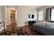 Spacious bedroom boasts a television and sleek hardwood floors at 7810 Whitemarsh Way, Reunion, FL 34747