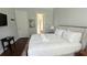 Cozy bedroom with a queen bed, bathroom access, neutral decor, and a serene ambiance at 7810 Whitemarsh Way, Reunion, FL 34747