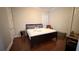 Spacious bedroom with a large bed, hardwood floors, a window, and a cozy seating area at 7810 Whitemarsh Way, Reunion, FL 34747
