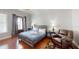 Spacious bedroom boasts a queen bed, sleek hardwood floors, and an access door at 7810 Whitemarsh Way, Reunion, FL 34747