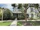 Charming two-story home with a well-maintained lawn and front garden, complemented by mature trees and a paved walkway at 7810 Whitemarsh Way, Reunion, FL 34747