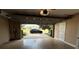 Spacious garage with ample storage and a view of the neighborhood and a parked car at 7810 Whitemarsh Way, Reunion, FL 34747
