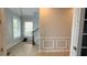 Hallway features two windows with blinds, a staircase, and white trim at 7810 Whitemarsh Way, Reunion, FL 34747