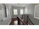 Bright hallway with wood floors, decorative wall accents, and multiple windows for natural light at 7810 Whitemarsh Way, Reunion, FL 34747