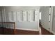 Hallway with unique boat-themed decorative trim on the walls and hardwood floors at 7810 Whitemarsh Way, Reunion, FL 34747