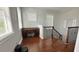 Upstairs hallway with desk and chair, wood floors, natural light, and staircase at 7810 Whitemarsh Way, Reunion, FL 34747