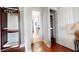 Hallway leads to a bathroom and a built-in closet with wooden features at 7810 Whitemarsh Way, Reunion, FL 34747