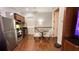 Efficient kitchenette next to a dining nook, featuring stainless steel appliances and wooden cabinets at 7810 Whitemarsh Way, Reunion, FL 34747
