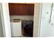 Convenient laundry room featuring a modern washer and dryer and ample cabinet space for storage at 7810 Whitemarsh Way, Reunion, FL 34747