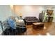 Bright living room with a comfy sofa, daybed and modern stainless steel appliances in the kitchenette at 7810 Whitemarsh Way, Reunion, FL 34747