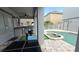 Covered outdoor kitchen and dining area beside the pool, great for entertaining guests at 7810 Whitemarsh Way, Reunion, FL 34747