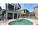 Resort style pool area featuring a spa, putting green, covered patio, and fenced yard perfect for outdoor living at 7810 Whitemarsh Way, Reunion, FL 34747