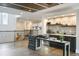 Charming bar with modern cabinets and open shelving adjacent to hardwood flooring and staircase at 9080 Morgana Ct, Winter Garden, FL 34787